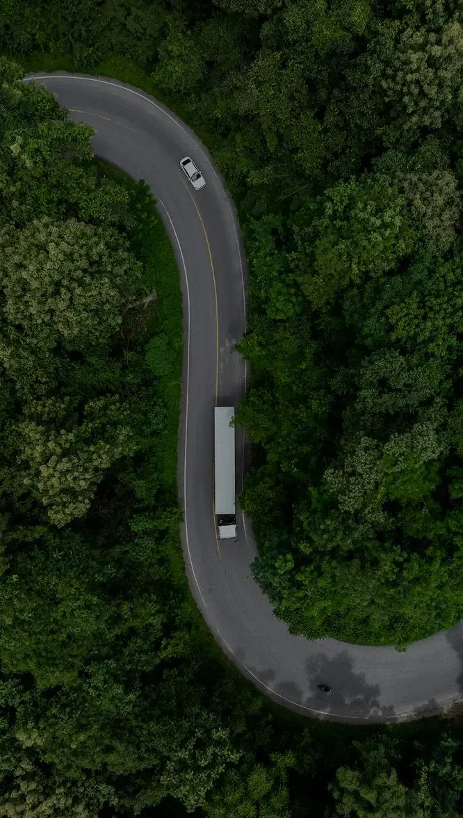birds eye view of truck going down road-overlay